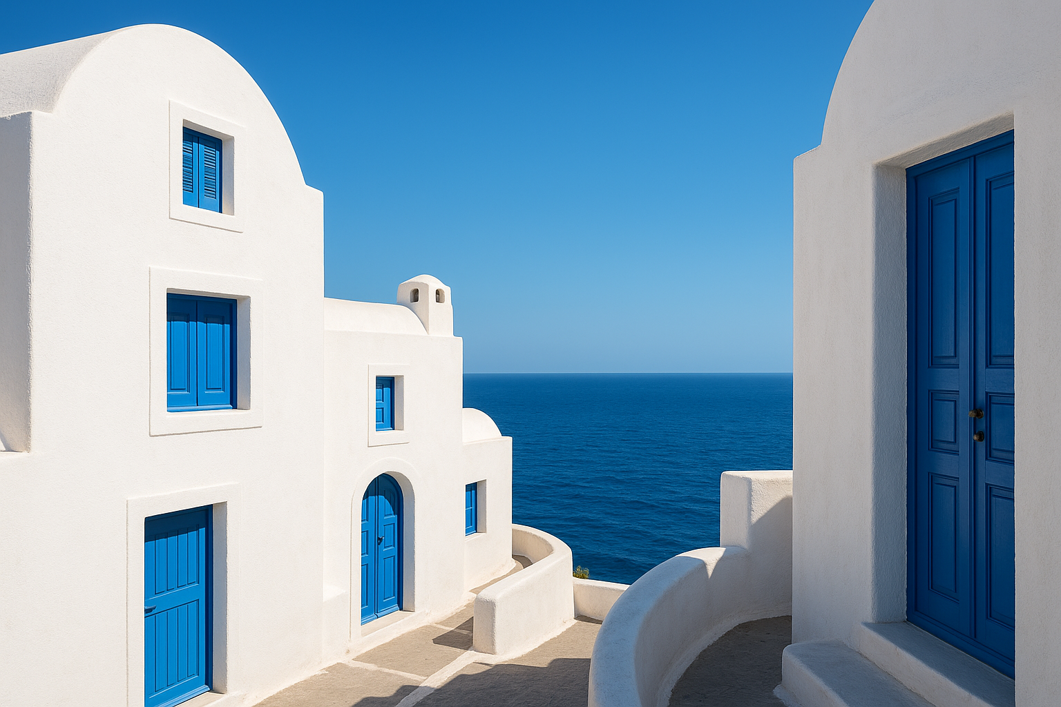 Traditional Mediterranean whitewashed buildings with bright blue doors and shutters overlooking azure sea