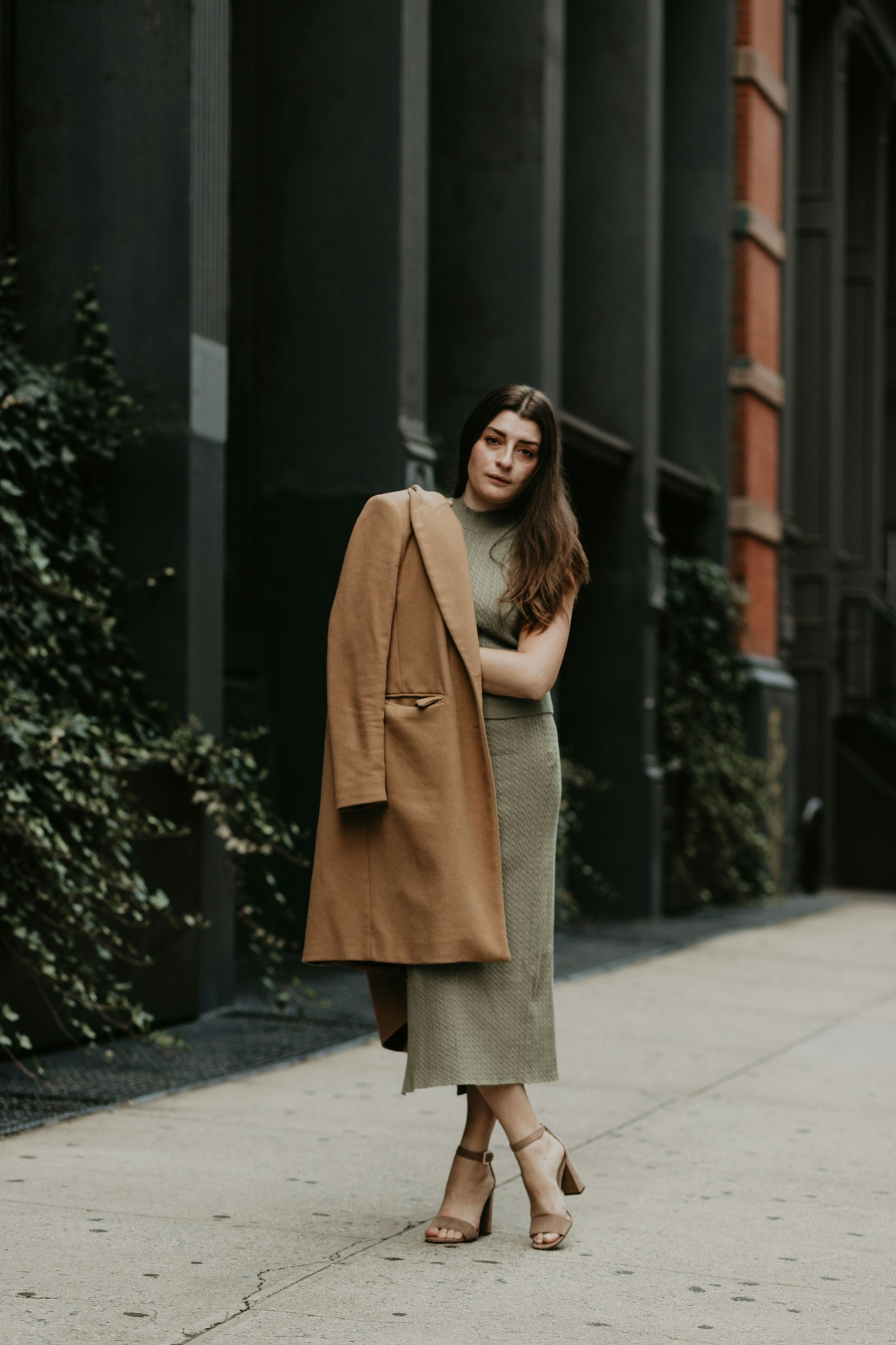 Camel coat over an olive knit set: two warm neutrals together